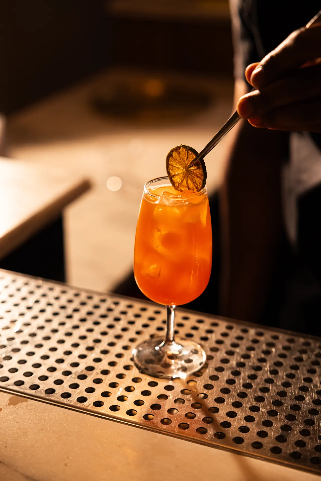Spritz with a dehydrated orange garnish at Bar Mezzo cocktail bar, photographed by Orange Grove Social