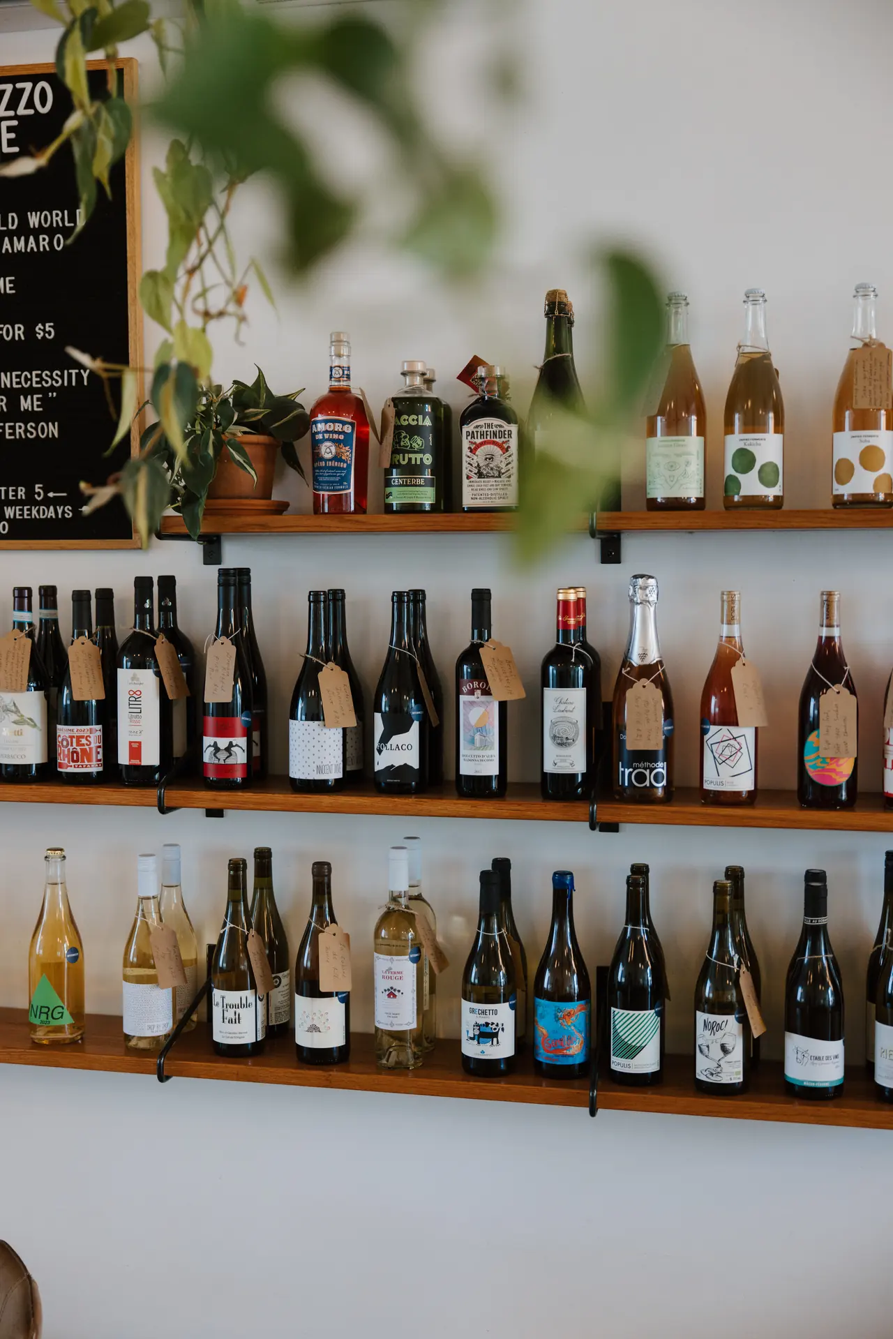 Wine bottle wall inside Intermezzo cafe in St. Petersburg, photographed by Orange Grove Social