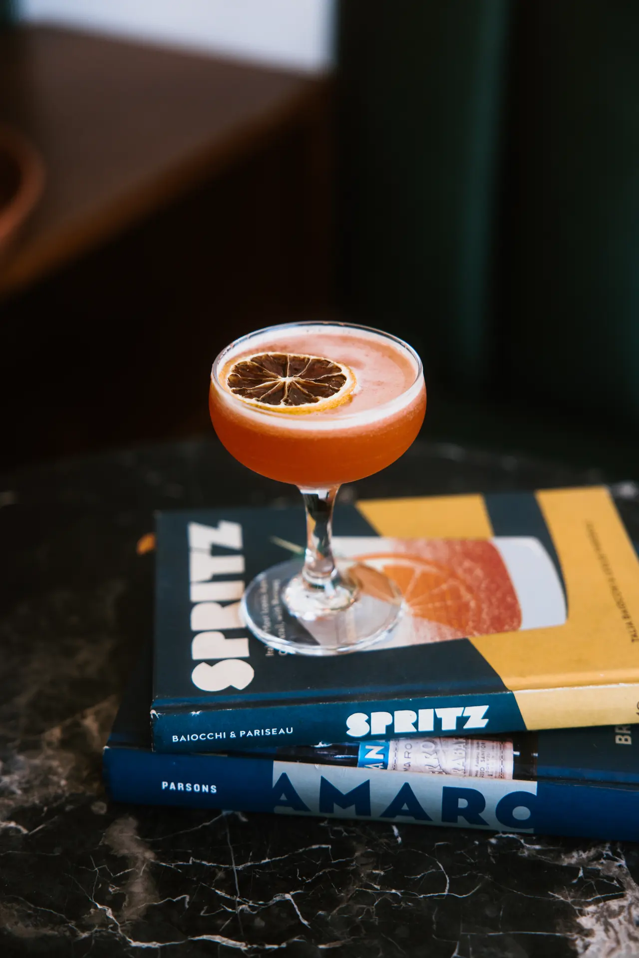 Spritz cocktail on cocktail books at Intermezzo in St. Petersburg, FL, photographed by Orange Grove Social