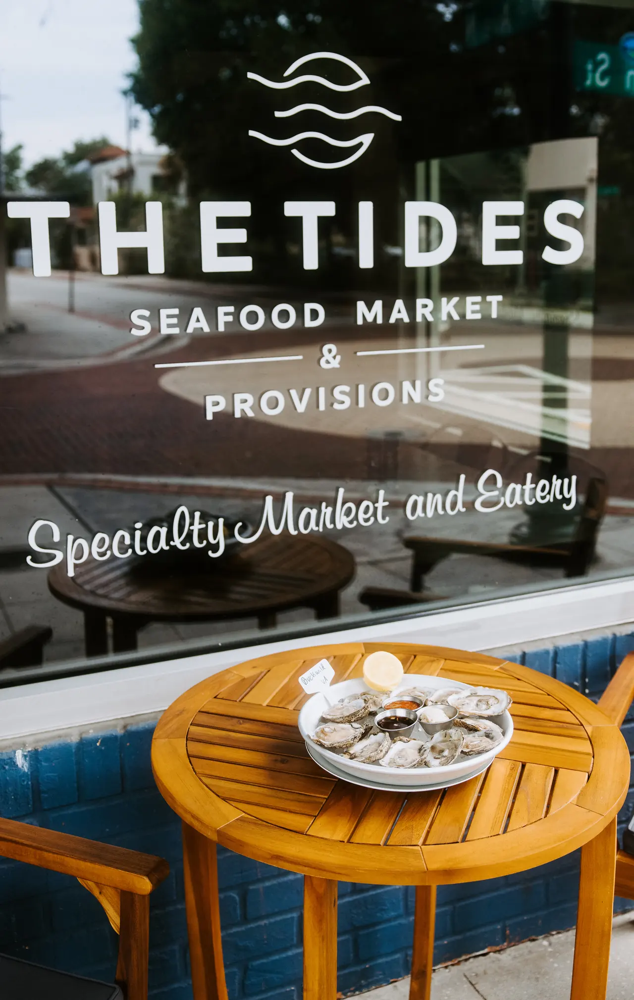 The Tides Seafood Market storefront window in Safety Harbor, FL, photographed by Orange Grove Social