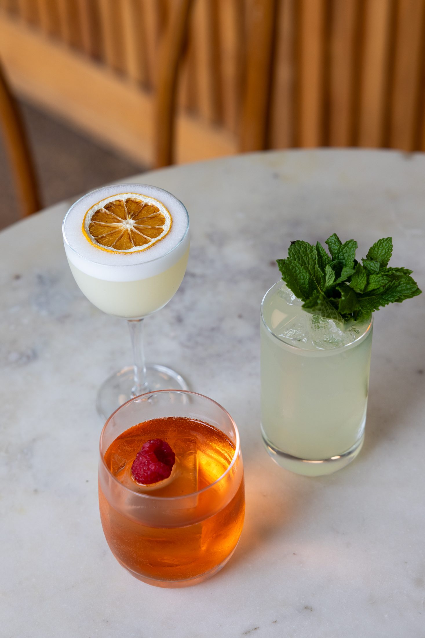 Three cocktails on a marble table at Intermezzo, St. Petersburg FL — bar photography by Orange Grove Social