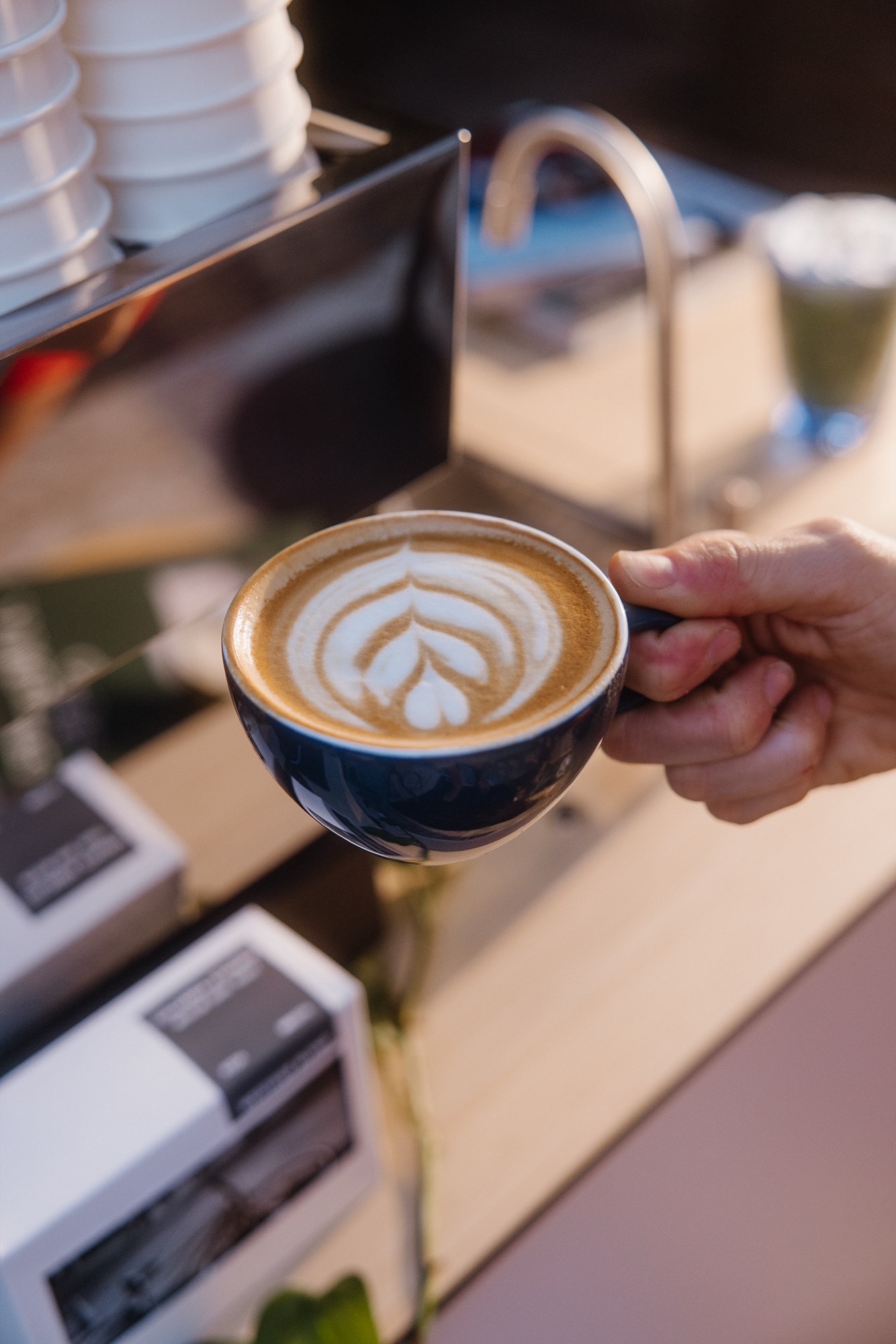 Latte art in a branded cup — coffee brand content by Orange Grove Social